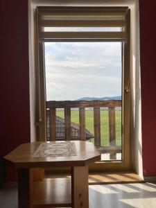 a table in front of a window with a view at Penzion Kohout in Nýrsko