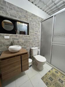 a bathroom with a toilet and a sink and a shower at Villa Mara in Filandia
