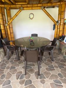 a dining room with a glass table and chairs at Villa Mara in Filandia