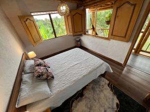 a bedroom with a bed and two windows at Villa Mara in Filandia