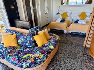 a living room with a couch and two beds at Stunning View Seaside 1-Bed Apartment in Saronida in Saronida