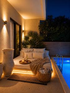 a bedroom with a bed on a patio at night at Villa Almihauss - Adults Only in Afantou