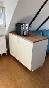 a white cabinet with a microwave on top of it at Fischerhaus Herstelle in Beverungen