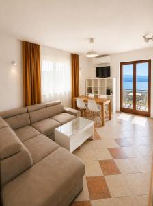 a living room with a couch and a table at Apartments Micic in Lovran