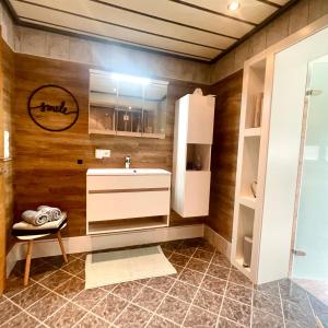 a bathroom with a sink and a mirror at Apartment WEITBLICK in Wald im Pinzgau +38 photos