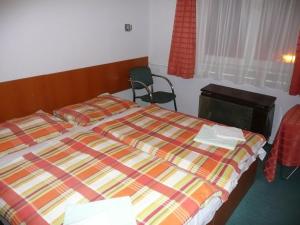 Postel nebo postele na pokoji v ubytování Hotel Touring