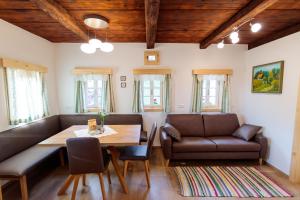 a dining room with a table and leather chairs at Ferienhaus Sterzhansl in Pongratzen
