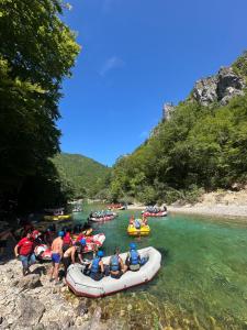a group of people rafting down a river at Rafting & Hostel in Konjic