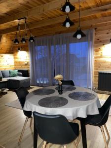 a dining room with a table and chairs in a room at Snowflake in Žabljak