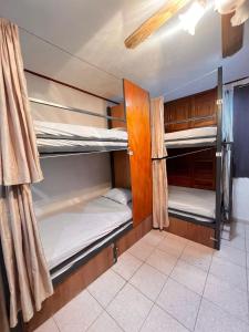 a room with three bunk beds in it at Hostel Treebu in Valladolid +57 photos
