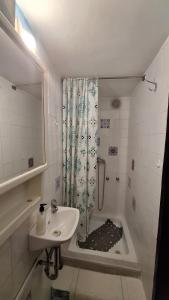 a bathroom with a sink and a shower at Shell in Rogoznica