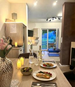 a wooden table with two plates of food on it at Apartment WEITBLICK in Wald im Pinzgau