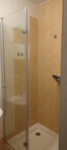 a shower with a glass door in a bathroom at Pokoje Gosia in Puck +16 photos