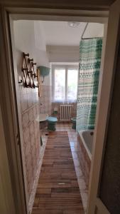 a bathroom with a tub and a toilet and a sink at Appartamento in Via Cardella in Pitigliano