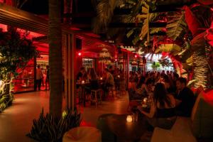 a group of people sitting at tables in a restaurant at Danaides in Malia +75 photos