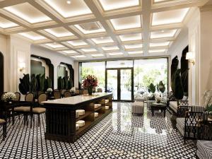 a lobby with a large room with a table and chairs at Grand KAS Premium Hotel & Sky Bar in Ho Chi Minh City