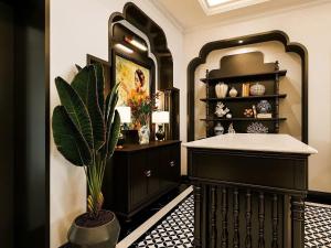 a bathroom with a black cabinet and a potted plant at Grand KAS Premium Hotel & Sky Bar in Ho Chi Minh City +59 photos