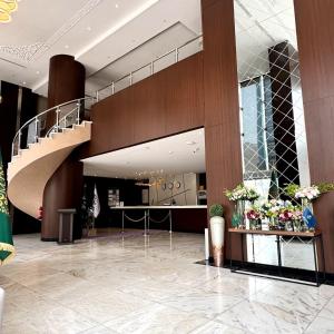 a lobby with a staircase in a building with flowers at Park Elite Hotel - فندق بارك إيليت in Mecca
