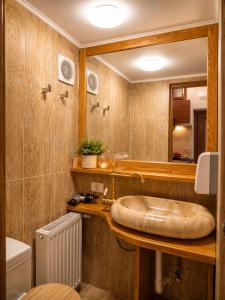 a bathroom with a sink and a mirror at History Apartments Cetății in Sibiu +46 photos