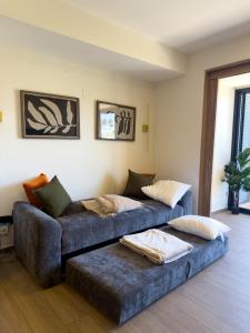 a living room with a couch with pillows on it at Loft en Zibata con Vista Alberca y Gym in La Cañada +16 photos