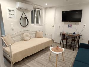 a bedroom with a bed and a table and a tv at LA CASA Di GIORGIO in Pentátion