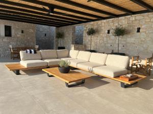a living room with a couch and a table at Villa Hillside Skiathos in Skiathos