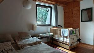 a baby room with a crib and a window at Dom Pod Salamandrą Koninki in Poręba Wielka