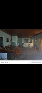 a large room with wooden benches and a table at Lions adventure in Narok