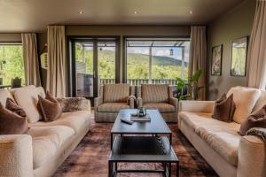 a living room with two couches and a table at Stort hus med jaquzzi in Geilo