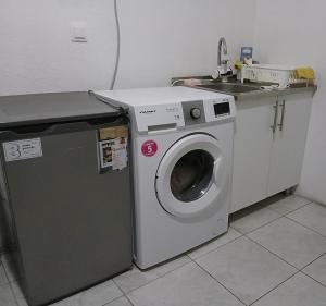 a washing machine and a sink in a kitchen at Charshija in Struga