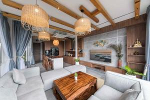a living room with a couch and a table at Sawasdee pool villa, Hua Hin in Hua Hin