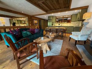 a living room with a couch and a table at Black Diamond Sainte Foy Chalets in Sainte-Foy-Tarentaise