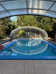 a swimming pool with a building in the background at Dvůr Stupice in Stupice