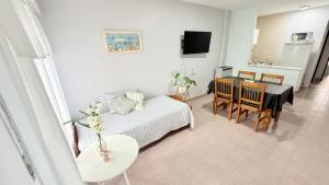 a bedroom with a bed and a table and a dining room at AltaMar in Playa Unión