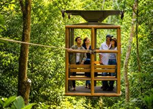 a group of people riding on a zip line at Hotel Boutique Maitta en Doradal Antioquia in Doradal