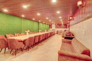a long dining room with a long table and chairs at HOTEL O SAFFRON in Meerut +36 photos