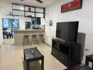 a living room with a flat screen tv on the wall at Casa Mango in Valladolid