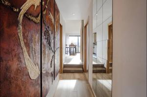 a hallway with a wall with a painting on it at Entre lac-montagnes et frontière in Contamine-sur-Arve