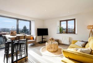 a living room with a couch and a table at Entre lac-montagnes et frontière in Contamine-sur-Arve
