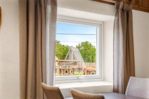 a window with a view of a house at Holmen Husky Lodge in Alta