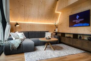 a living room with a couch and a tv at Holmen Husky Lodge in Alta