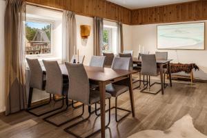 a dining room with a table and chairs at Holmen Husky Lodge in Alta