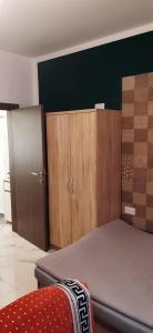a bedroom with a bed and wooden cabinets at Private small studio in Qrendi