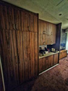 a kitchen with wooden cabinets and a sink at LUNAS Apartmani in Kopaonik
