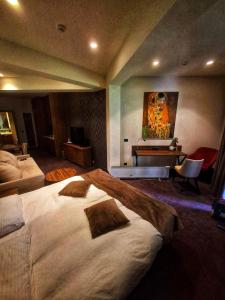a bedroom with a large bed and a desk at LUNAS Apartmani in Kopaonik