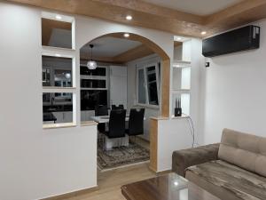 a living room with a couch and a table with chairs at Lux apartment in Dobra Voda