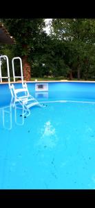 two chairs are sitting in a swimming pool at La bâtisse a deux tours in Lalbenque