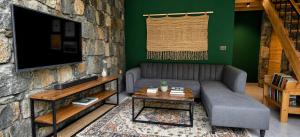 a living room with a couch and a tv at Lavender Resort Naran in Naran