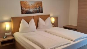 a bedroom with a large bed with white pillows at Apart Ritzl in Fügen