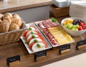 a buffet with different types of meats and cheese and bread at apartmenttwelve in Trogir